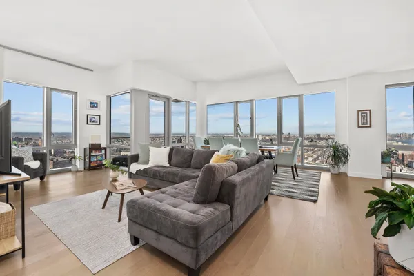 a living room with furniture dining area and a flat screen tv