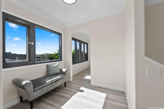 a view of a living room filled with furniture and a large window