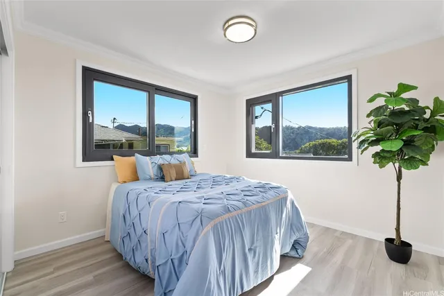 a bedroom with a bed and a large window