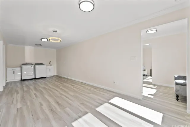 a view of a room with wooden floor and white walls