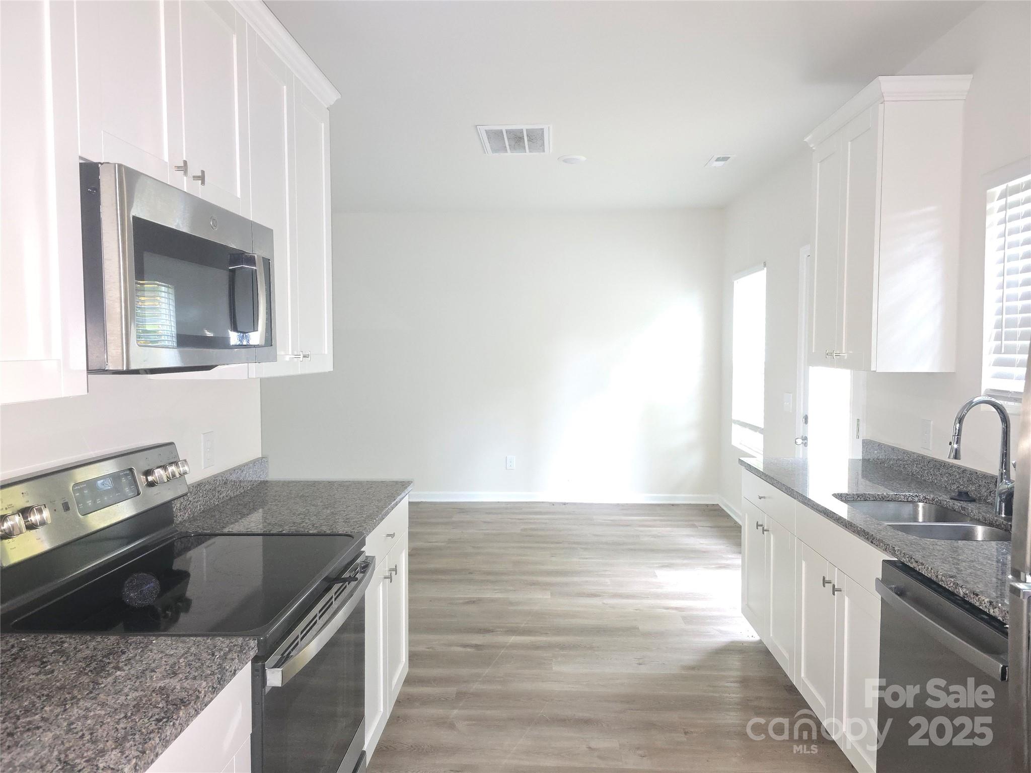103 Spring Drive Salisbury, NC 28144 - Photo 4 of 21 a kitchen with granite countertop a sink dishwasher stove and cabinets