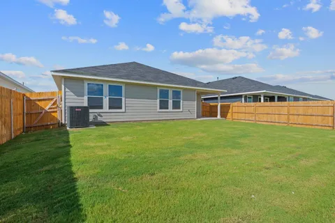 a view of a house with a backyard