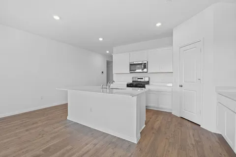 a kitchen with white cabinets and white appliances