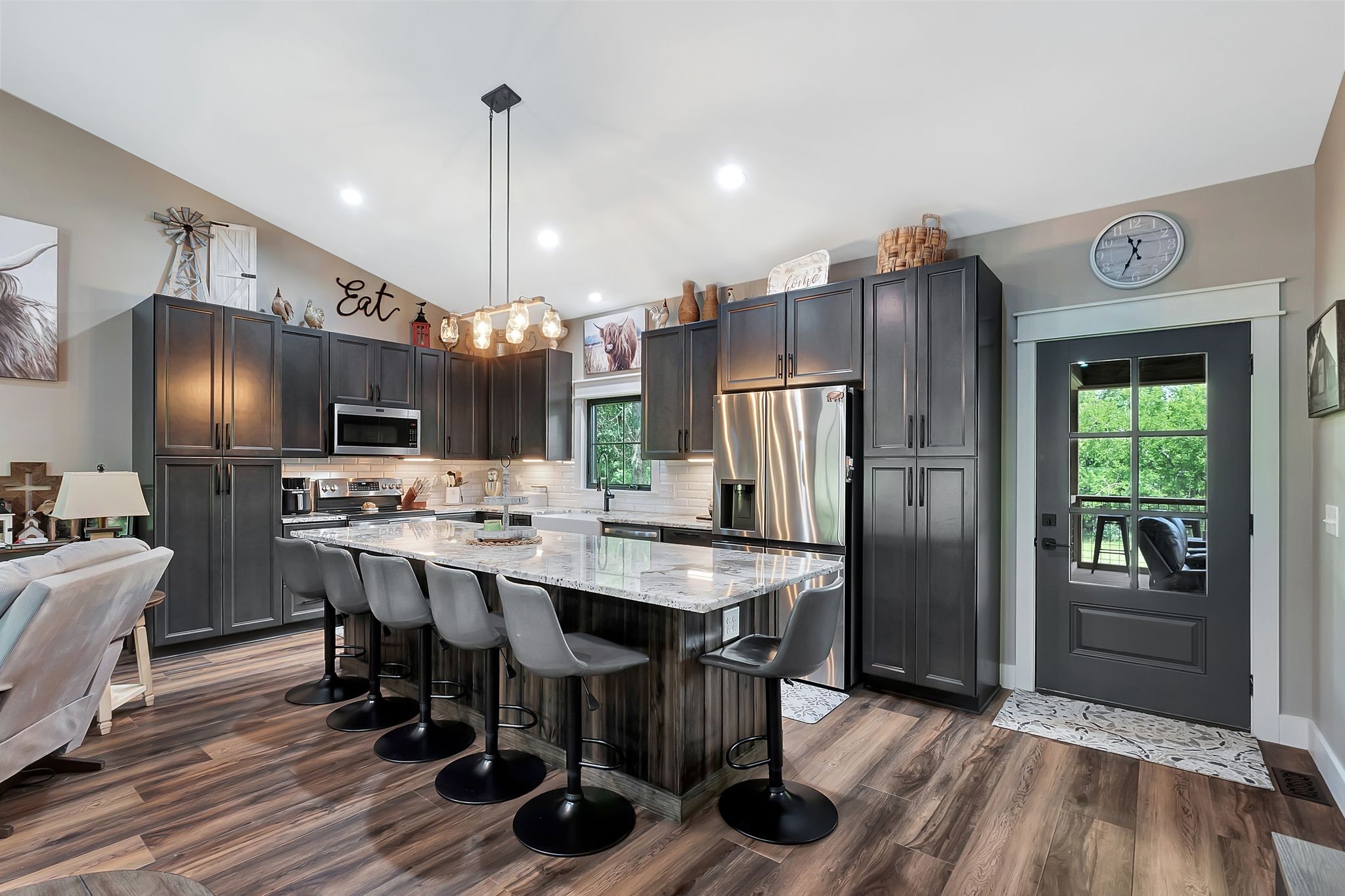 704 Beasleys Bend Road Lebanon, TN 37087 - Photo 17 of 35 a kitchen with stainless steel appliances a dining table chairs refrigerator and cabinets