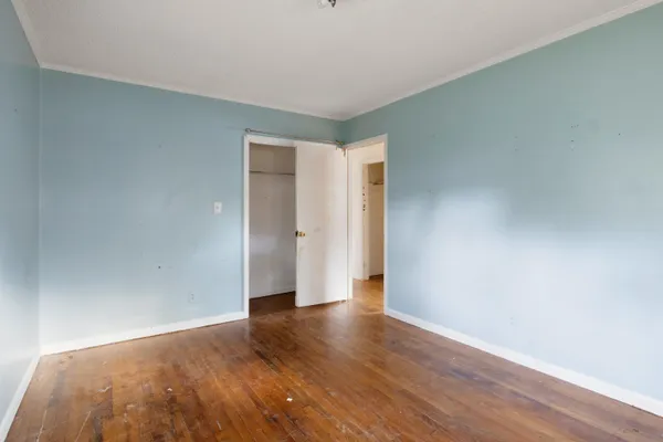 a view of an empty room and wooden floor