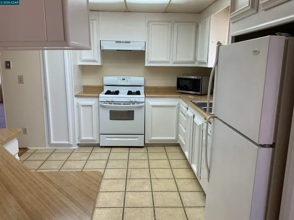 a kitchen with a stove a refrigerator and a sink