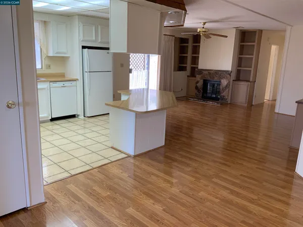 an empty room with wooden floor and cabinet