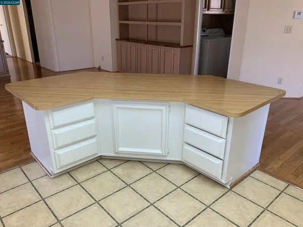a view of a utility room with cabinets