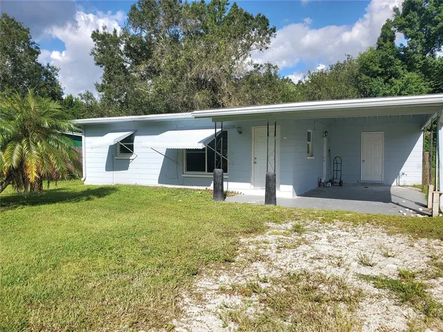 a view of an house with backyard space and garden