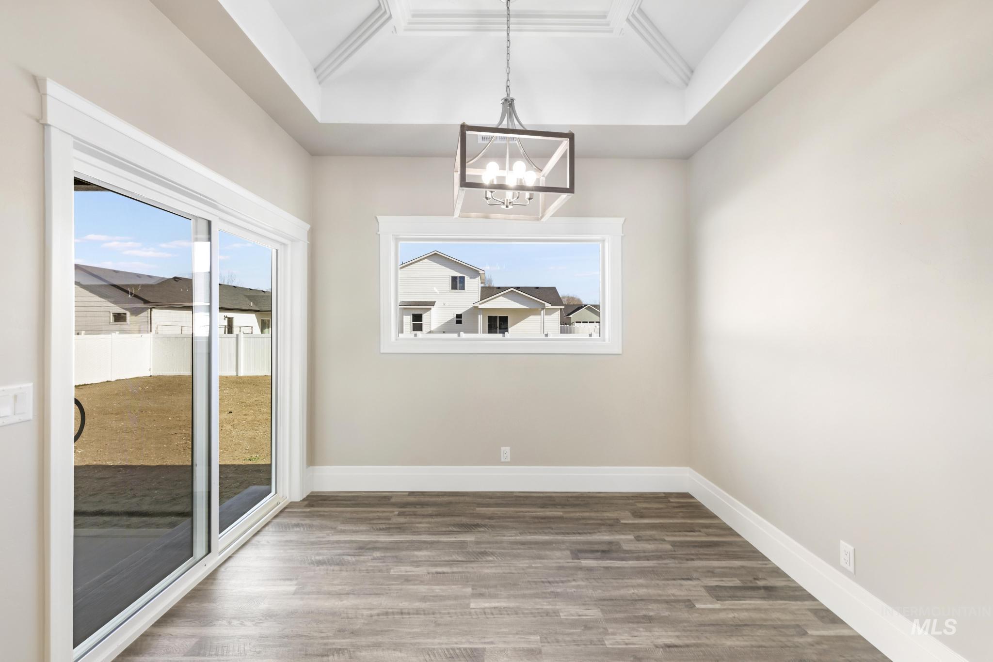 1316 K Street Rupert, ID 83350 - Photo 11 of 44 Unfurnished dining area featuring suspended lighting and wood finished floors