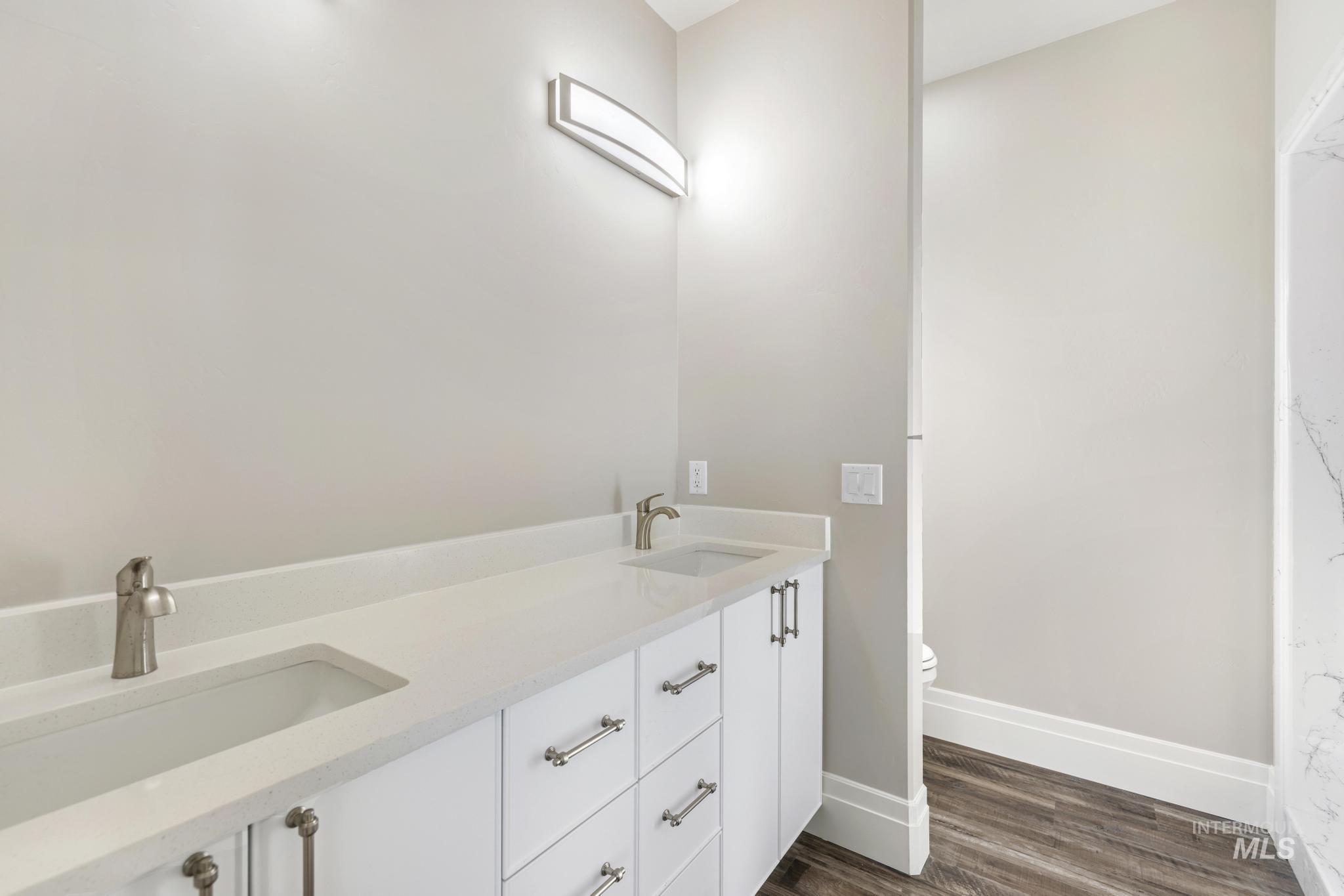 1316 K Street Rupert, ID 83350 - Photo 14 of 44 Full bathroom with double vanity and dark wood finished floors