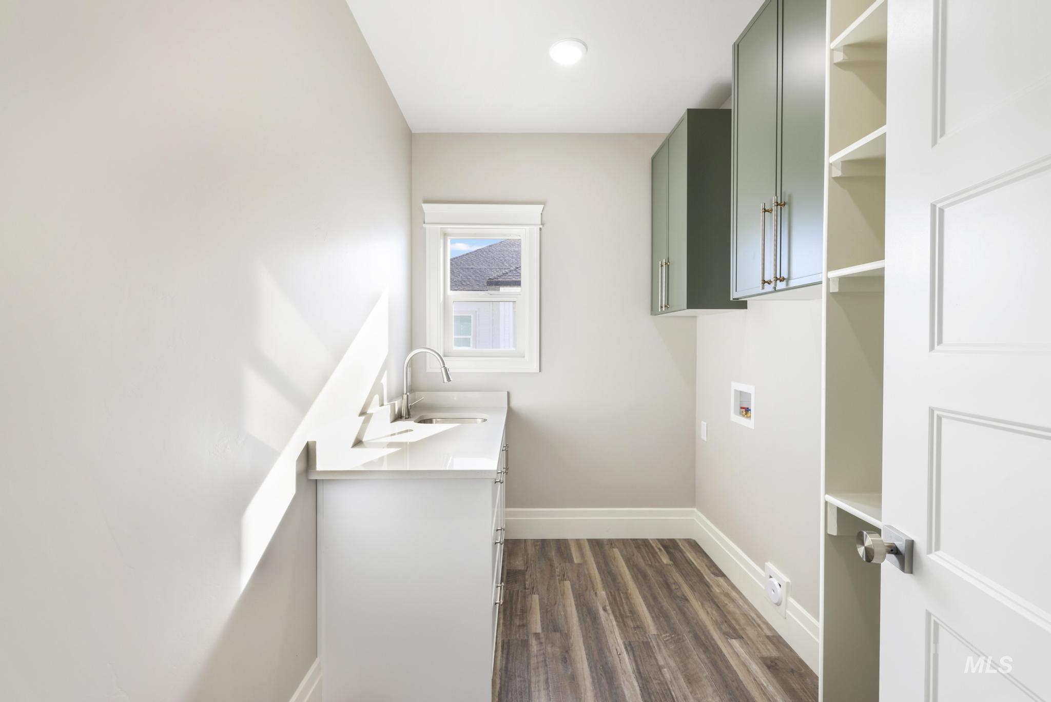 1316 K Street Rupert, ID 83350 - Photo 18 of 44 Laundry area with cabinet space, dark wood-style floors, and washer hookup