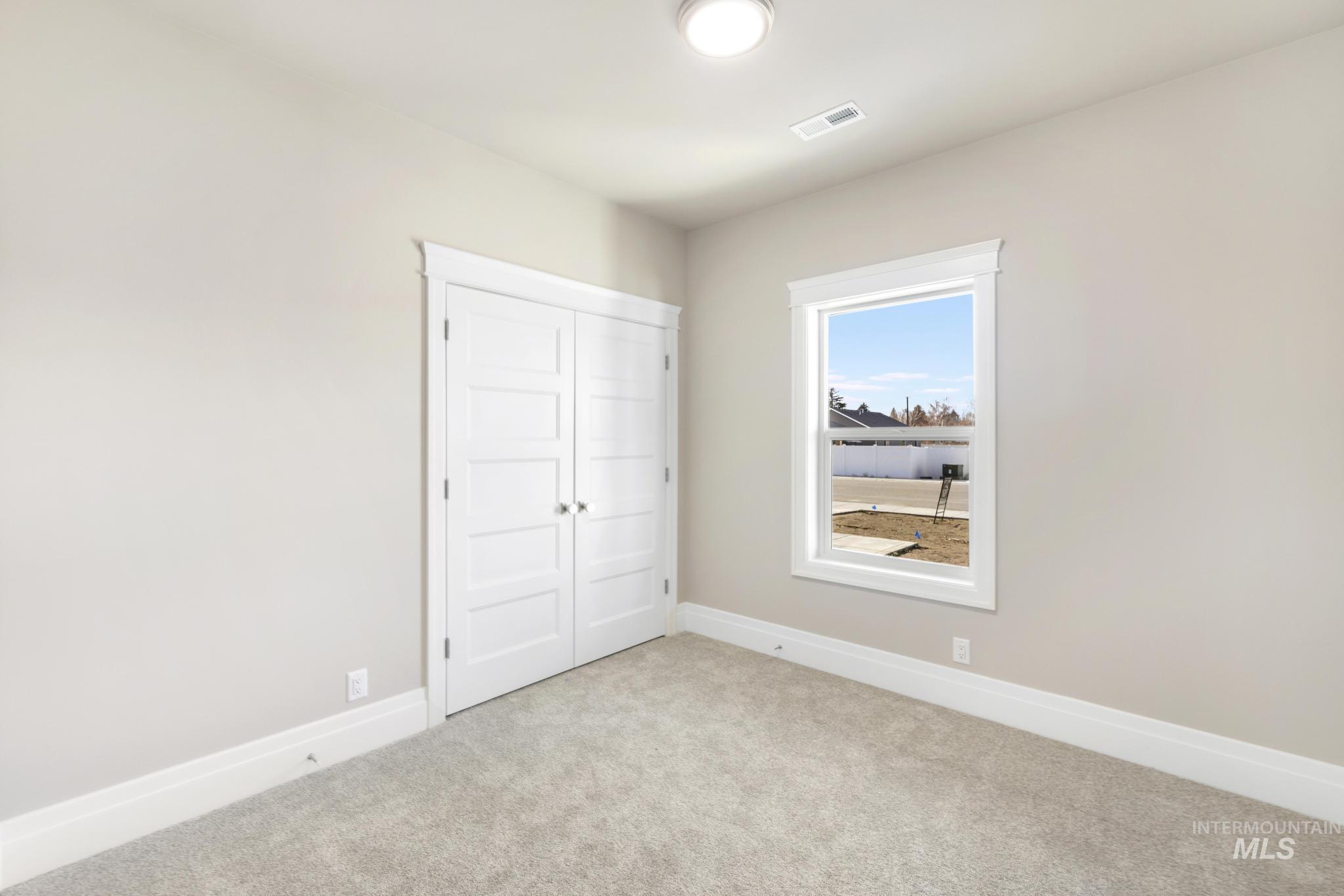 1316 K Street Rupert, ID 83350 - Photo 19 of 44 Unfurnished bedroom featuring carpet flooring and a closet