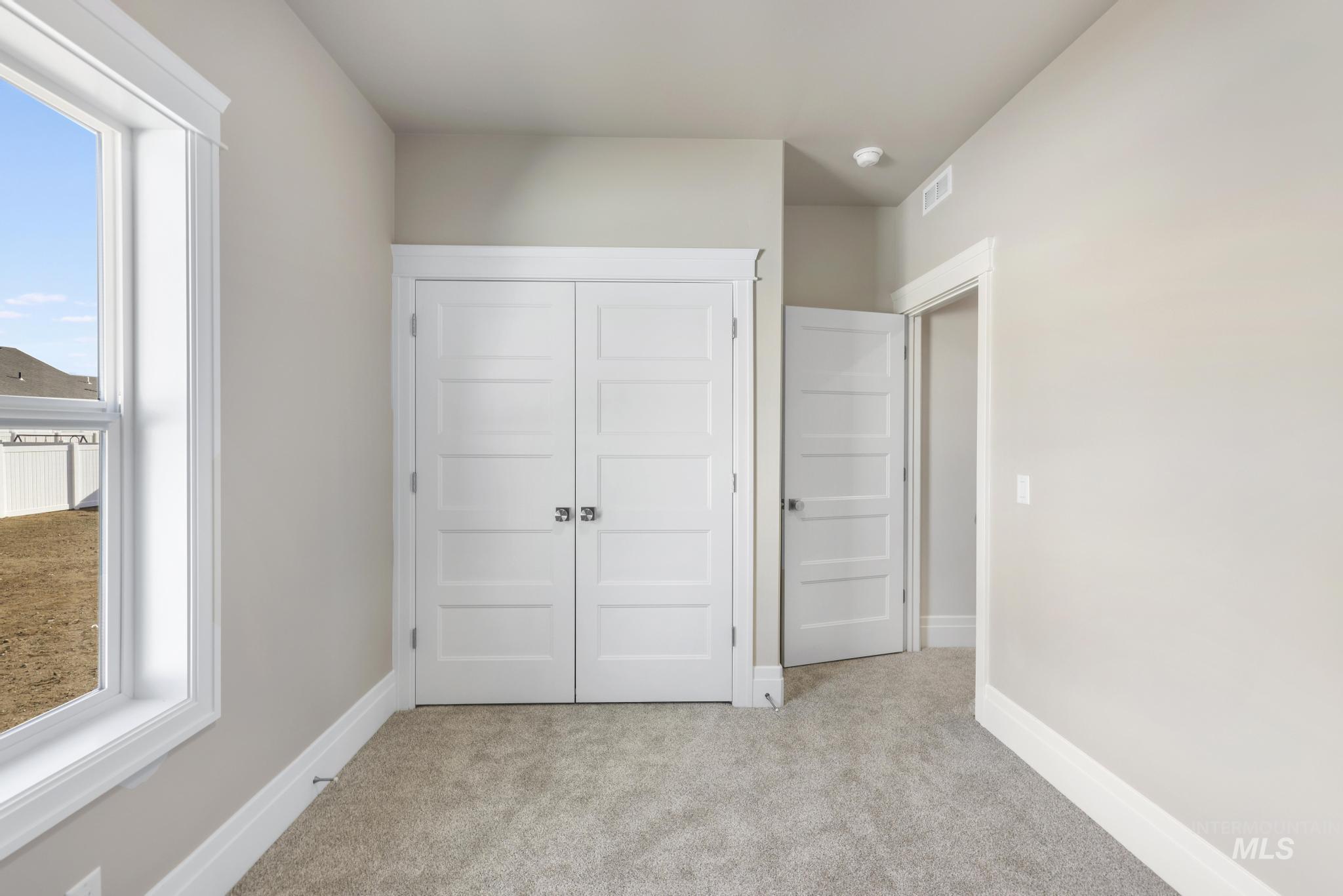 1316 K Street Rupert, ID 83350 - Photo 23 of 44 Unfurnished bedroom with light carpet and a closet