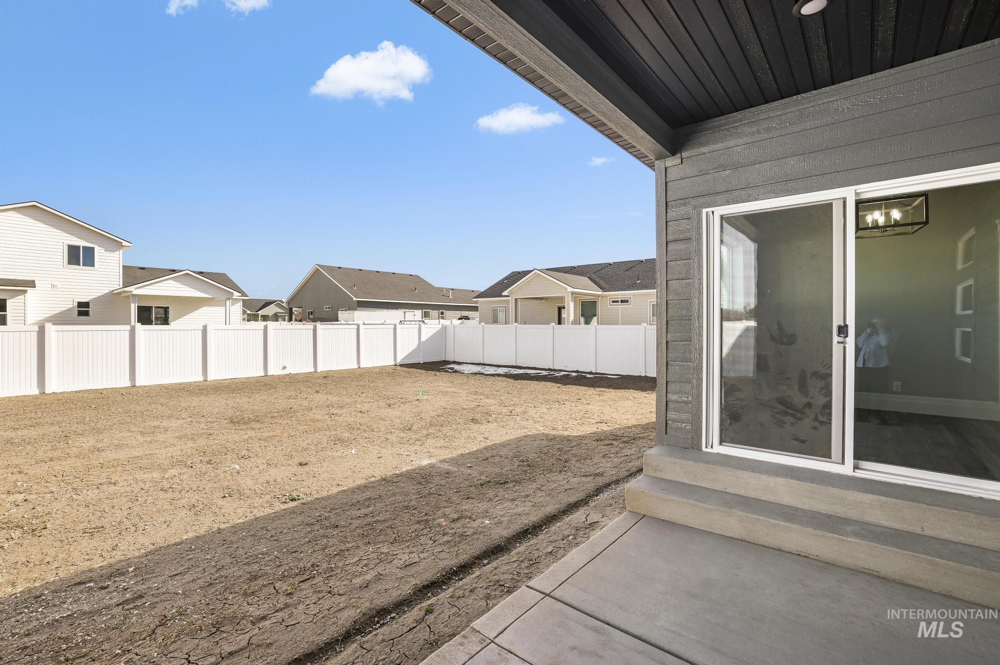 1316 K Street Rupert, ID 83350 - Photo 25 of 44 Fenced backyard with entry steps, a residential view, and a patio