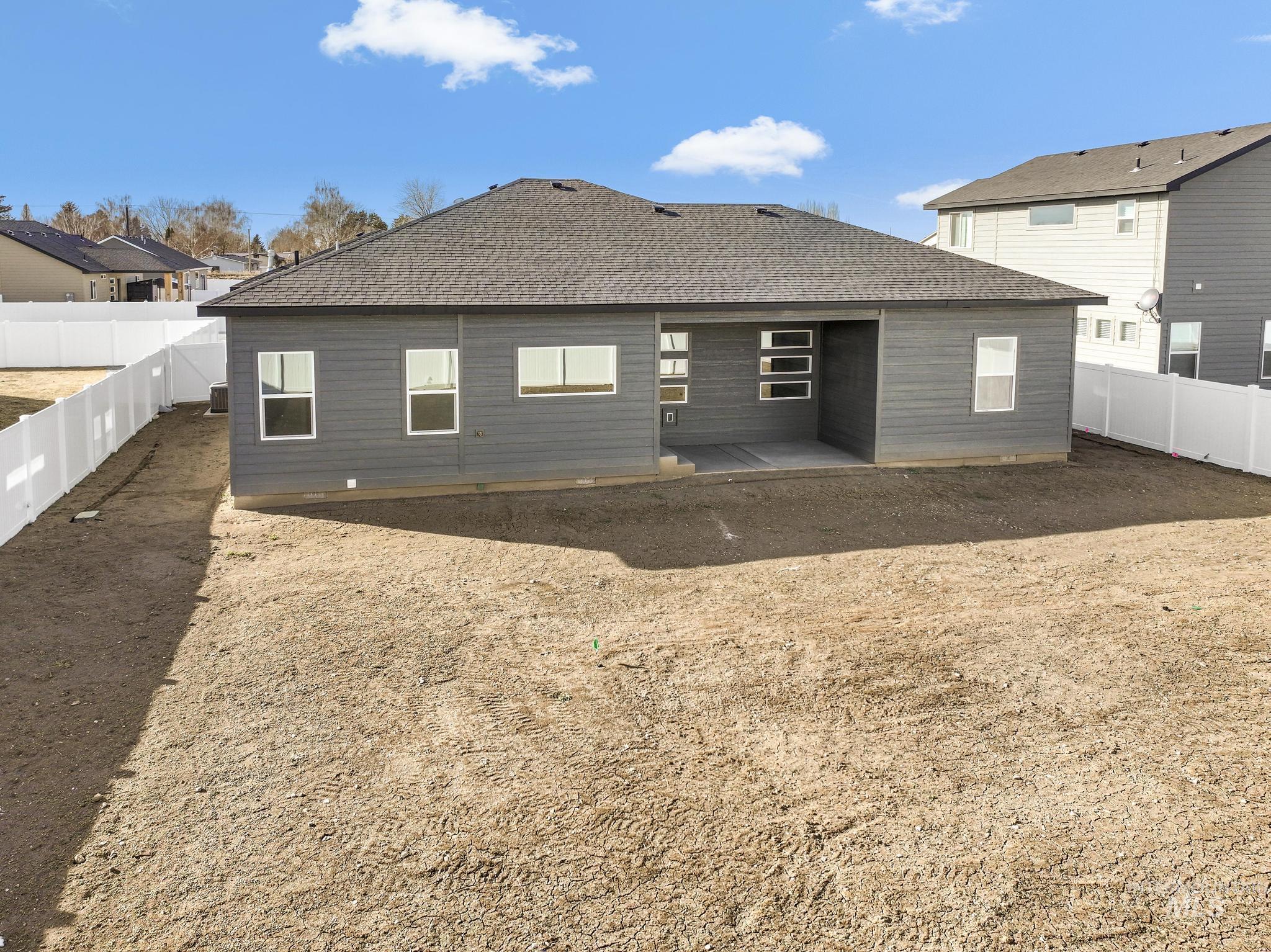 1316 K Street Rupert, ID 83350 - Photo 28 of 44 Rear view of house with a fenced backyard and a shingled roof
