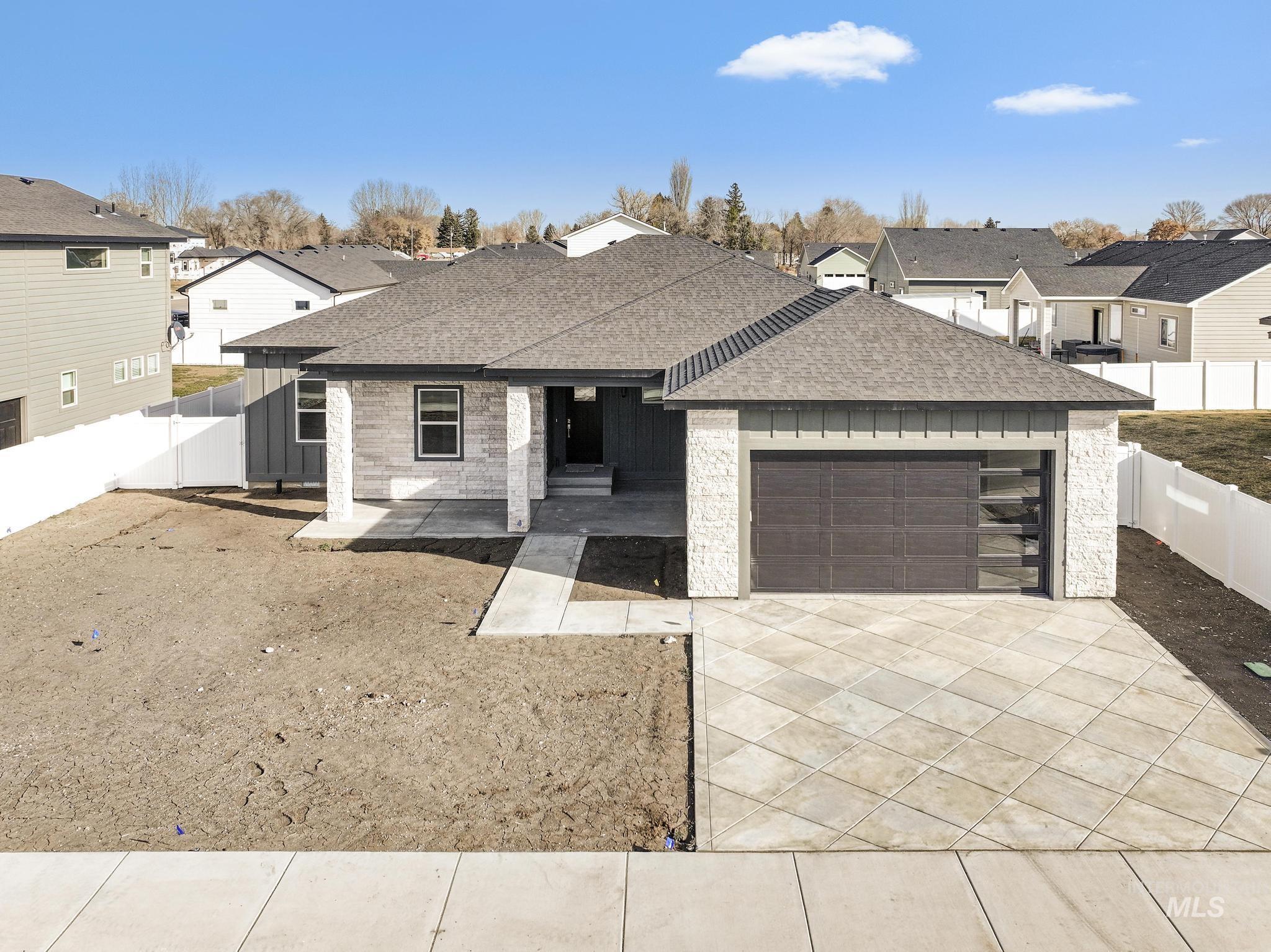 1316 K Street Rupert, ID 83350 - Photo 29 of 44 View of front of home featuring a shingled roof, a fenced backyard, and a residential view