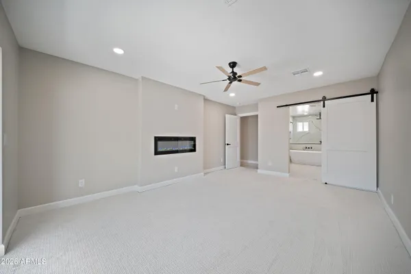a view of an empty room with a ceiling fan