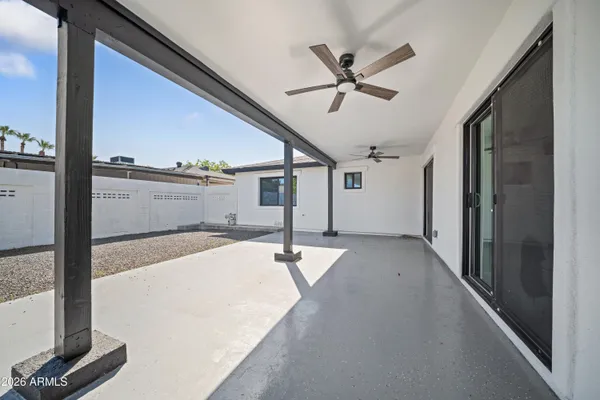a view of a hallway with a ceiling fan