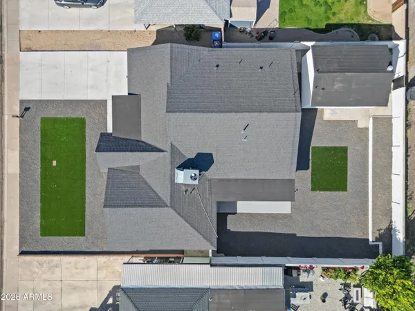 an aerial view of a house with a yard