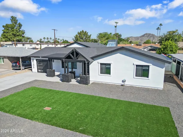 a aerial view of a house with swimming pool and a yard
