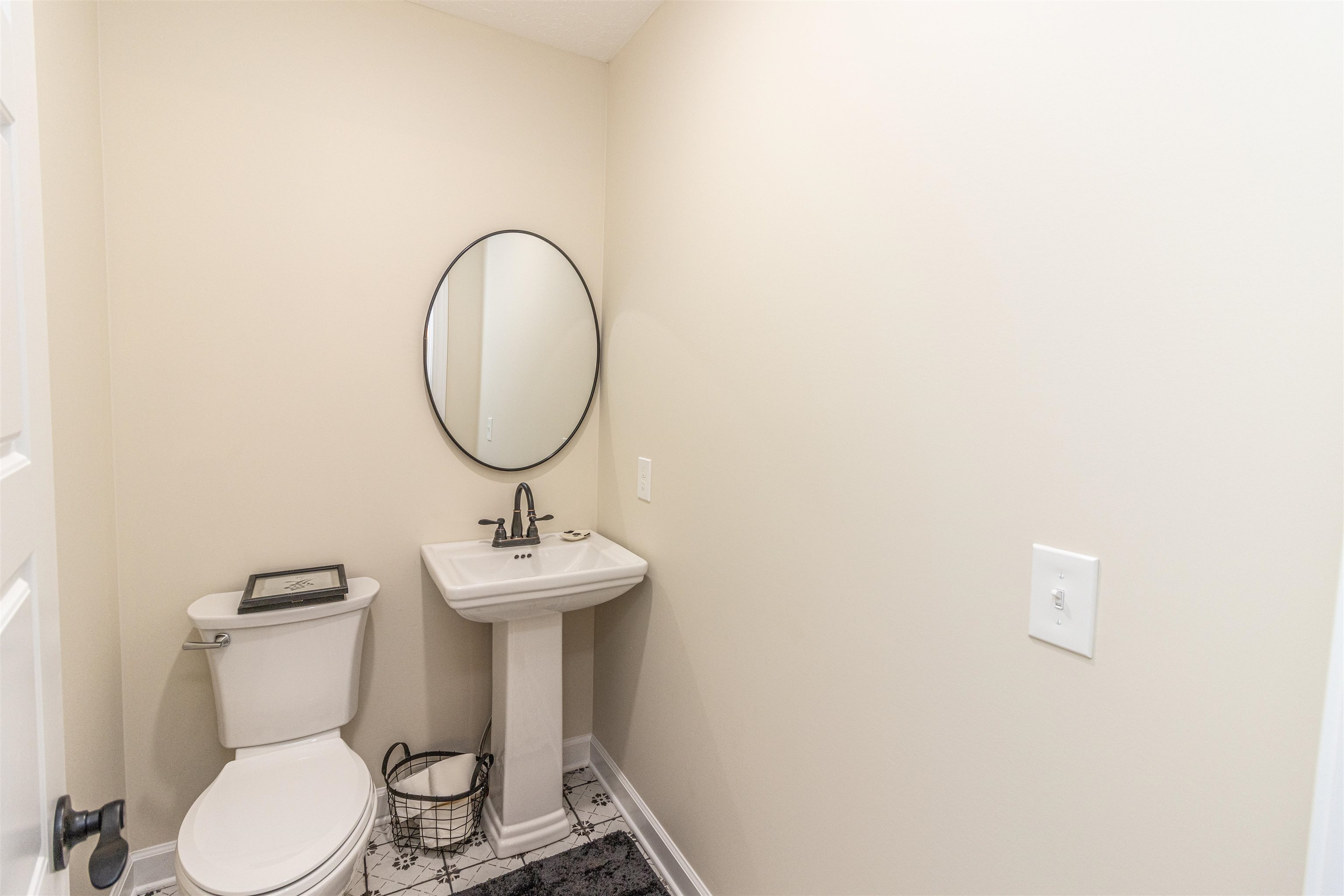 150 Windchase Cove Adamsville, TN 38310 - Photo 19 of 21 a bathroom with a sink mirror and toilet