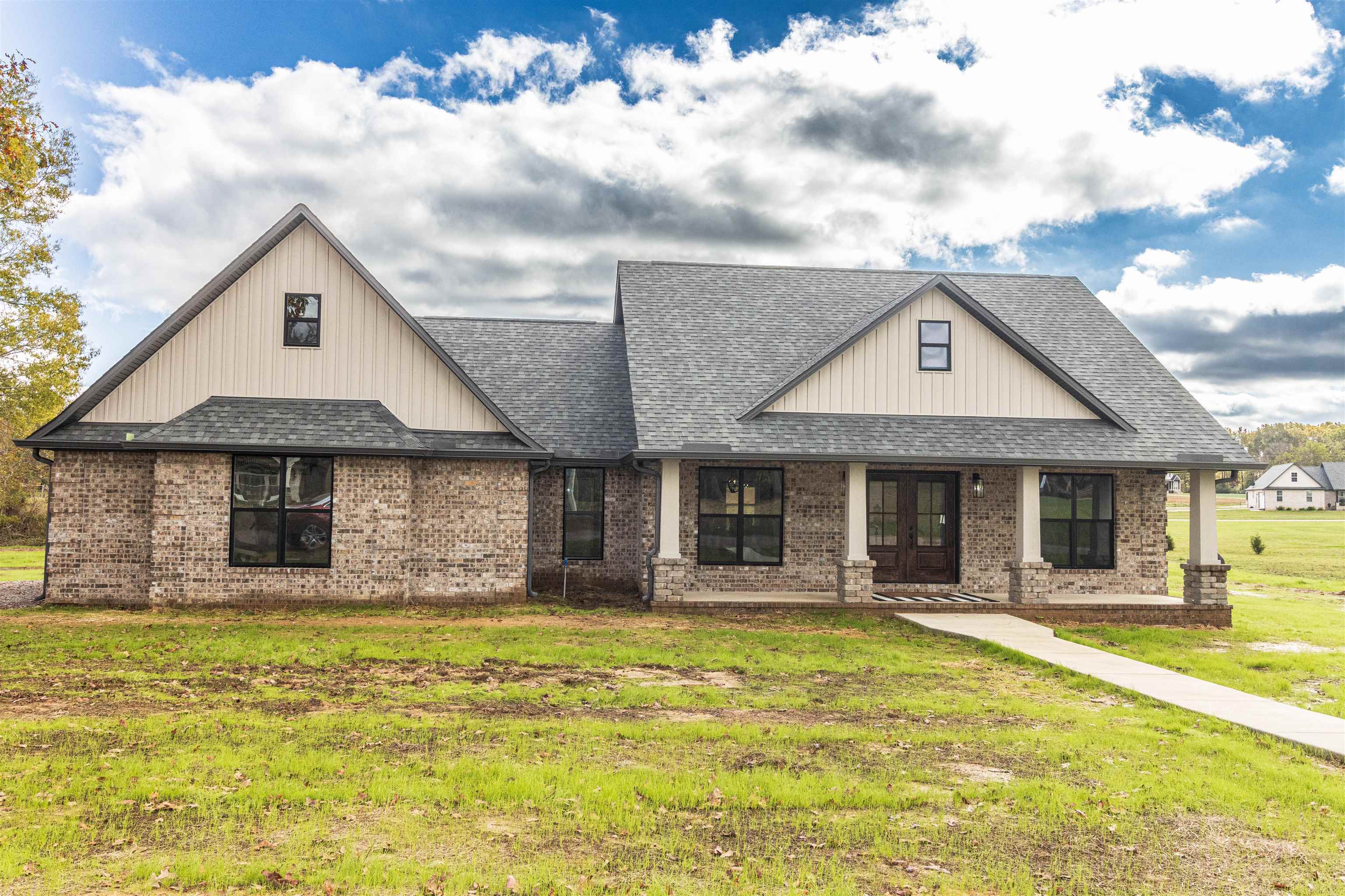 150 Windchase Cove Adamsville, TN 38310 - Photo 2 of 21 a front view of a house with swimming pool