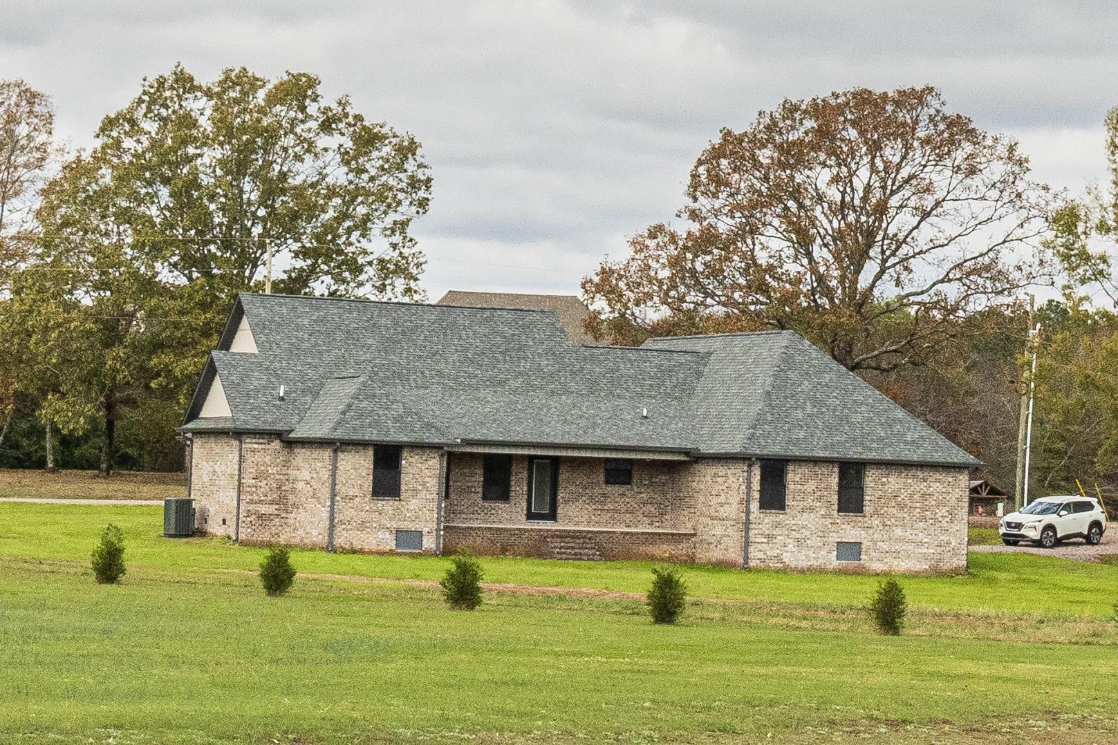 150 Windchase Cove Adamsville, TN 38310 - Photo 21 of 21 a front view of a house with swimming pool and yard