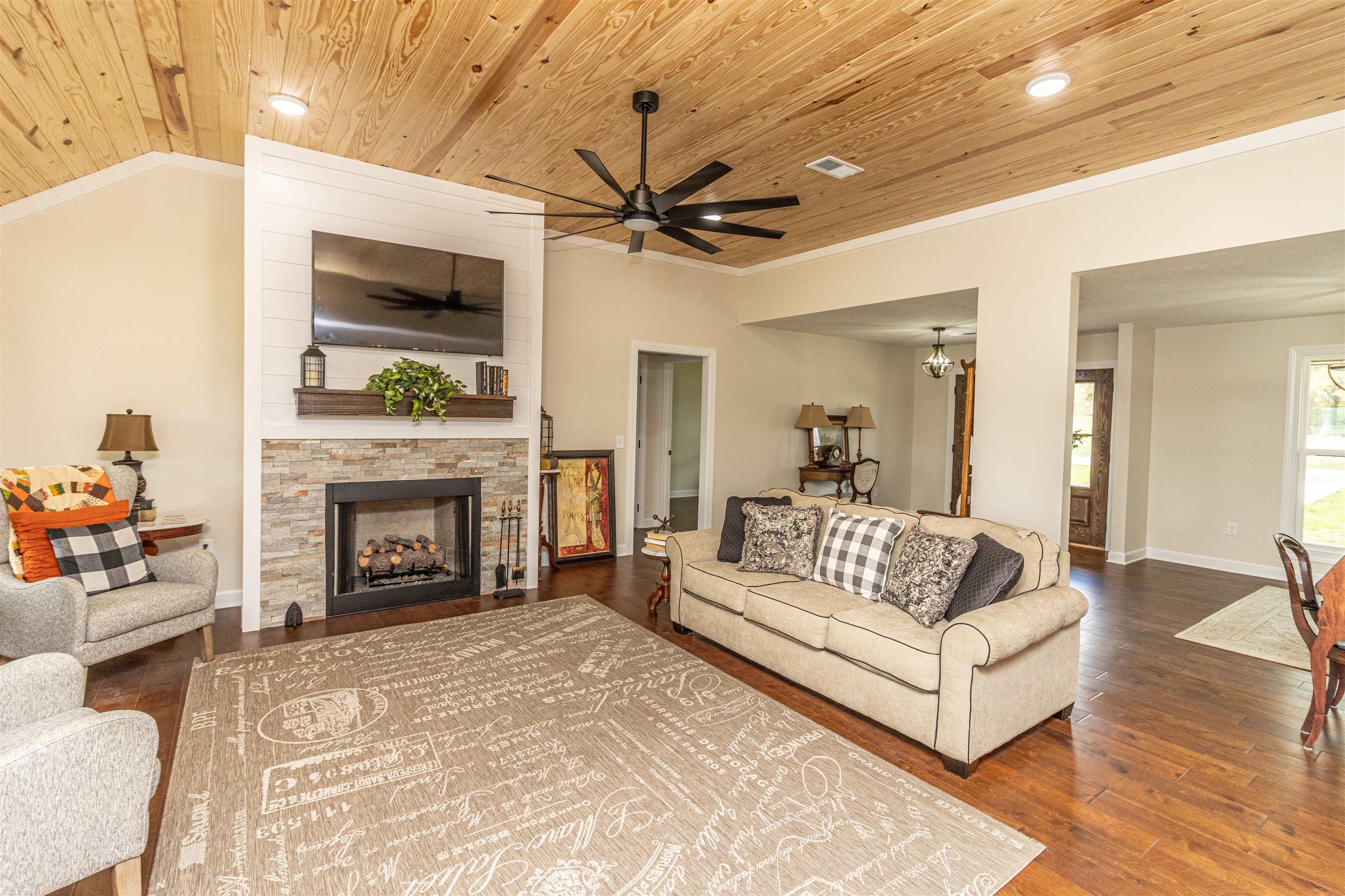 150 Windchase Cove Adamsville, TN 38310 - Photo 7 of 21 a living room with furniture a fireplace and a flat screen tv