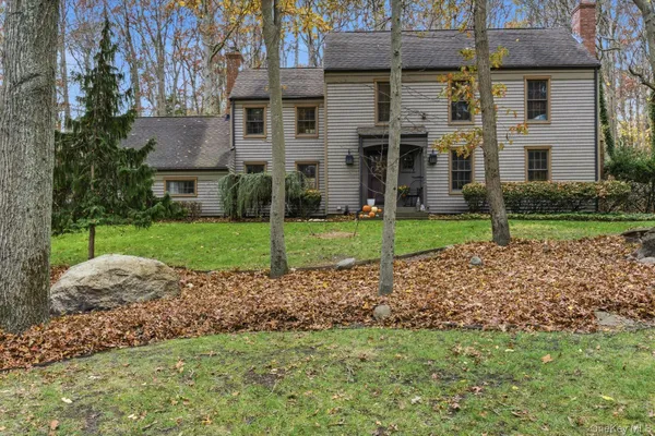 a view of a house with a yard and a patio