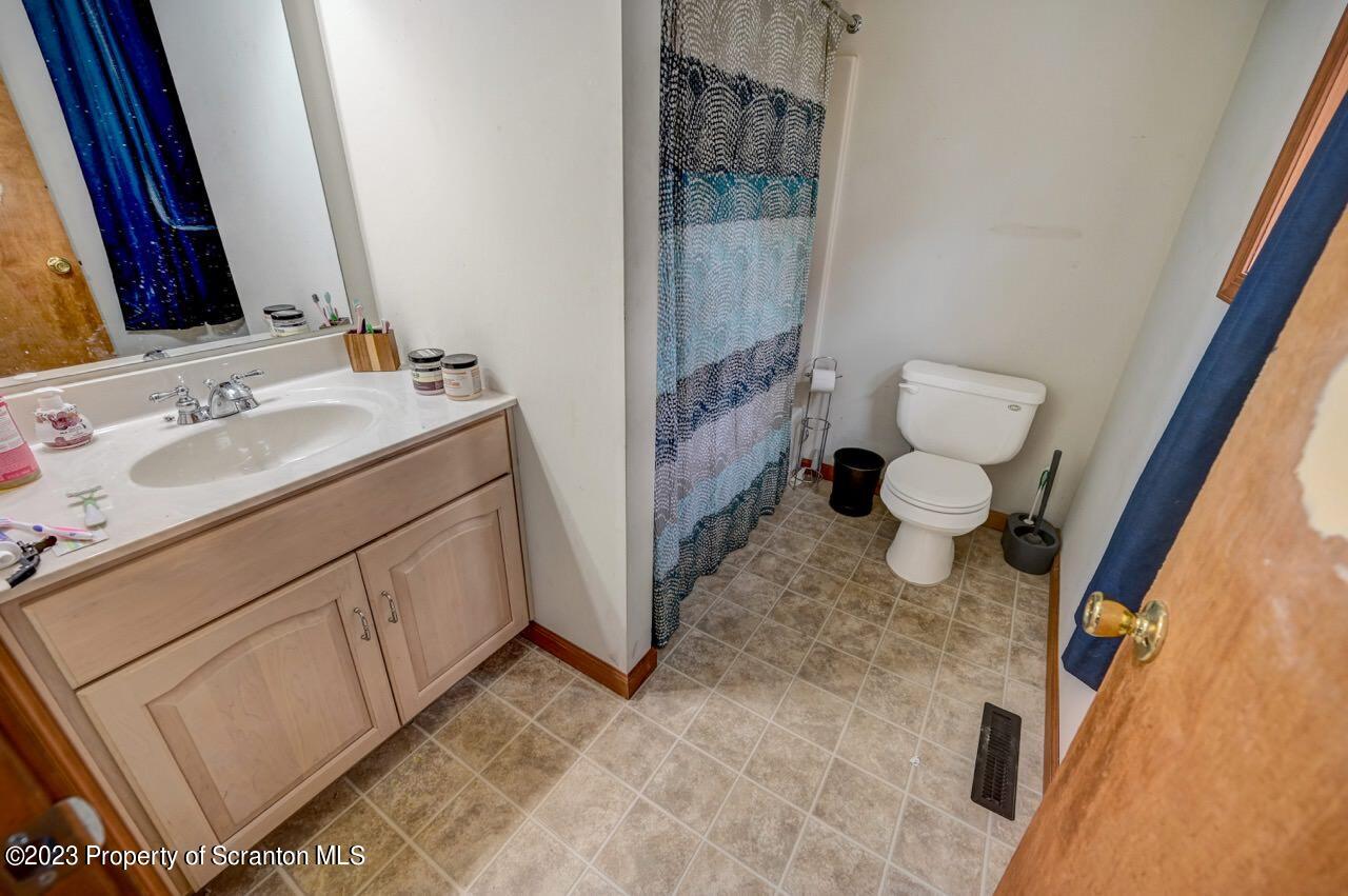 4156 Romeo Road Tobyhanna, PA 18466 - Photo 29 of 46 a bathroom with a sink and a mirror with toilet