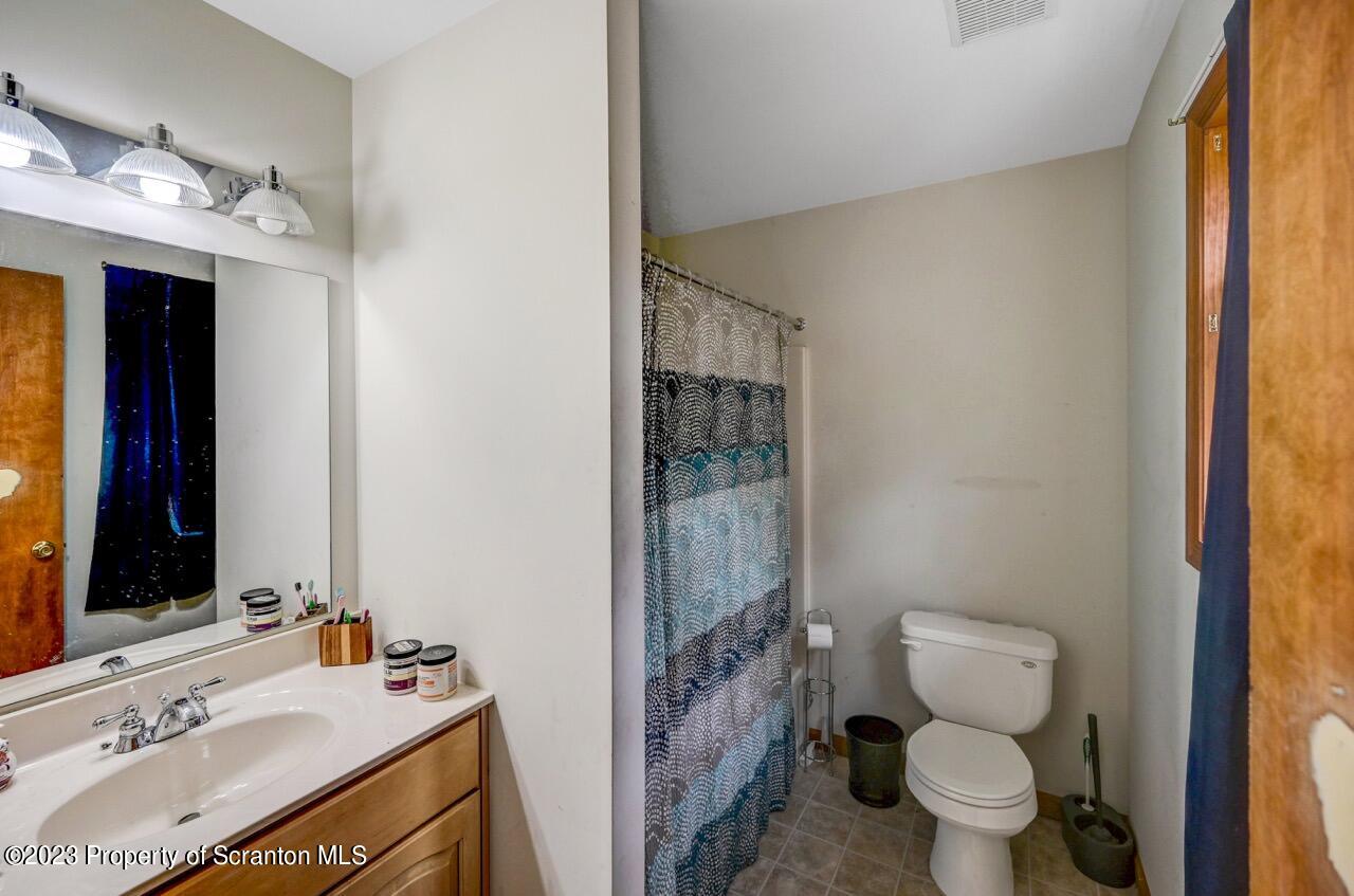 4156 Romeo Road Tobyhanna, PA 18466 - Photo 30 of 46 a bathroom with a sink vanity mirror and toilet