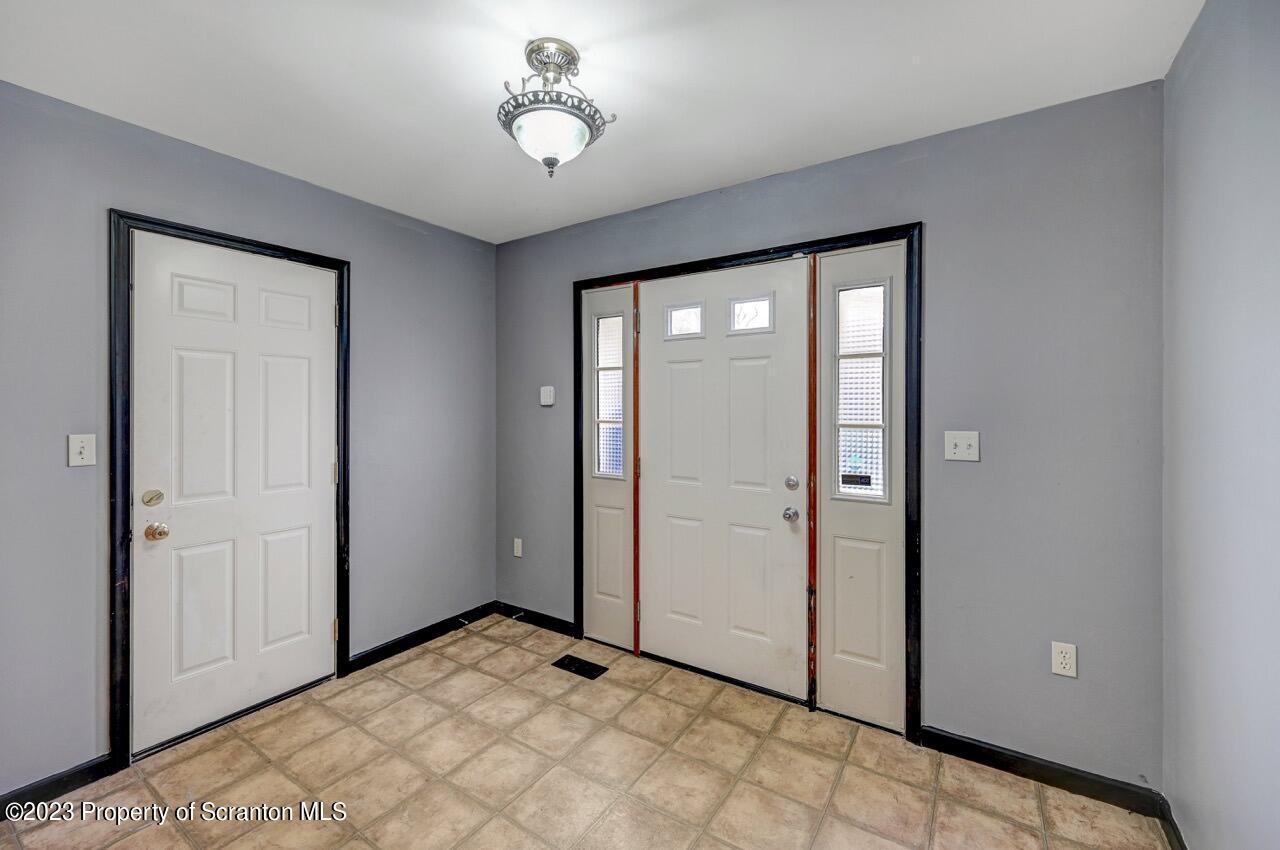 4156 Romeo Road Tobyhanna, PA 18466 - Photo 31 of 46 a view of a room with a chandelier fan and windows