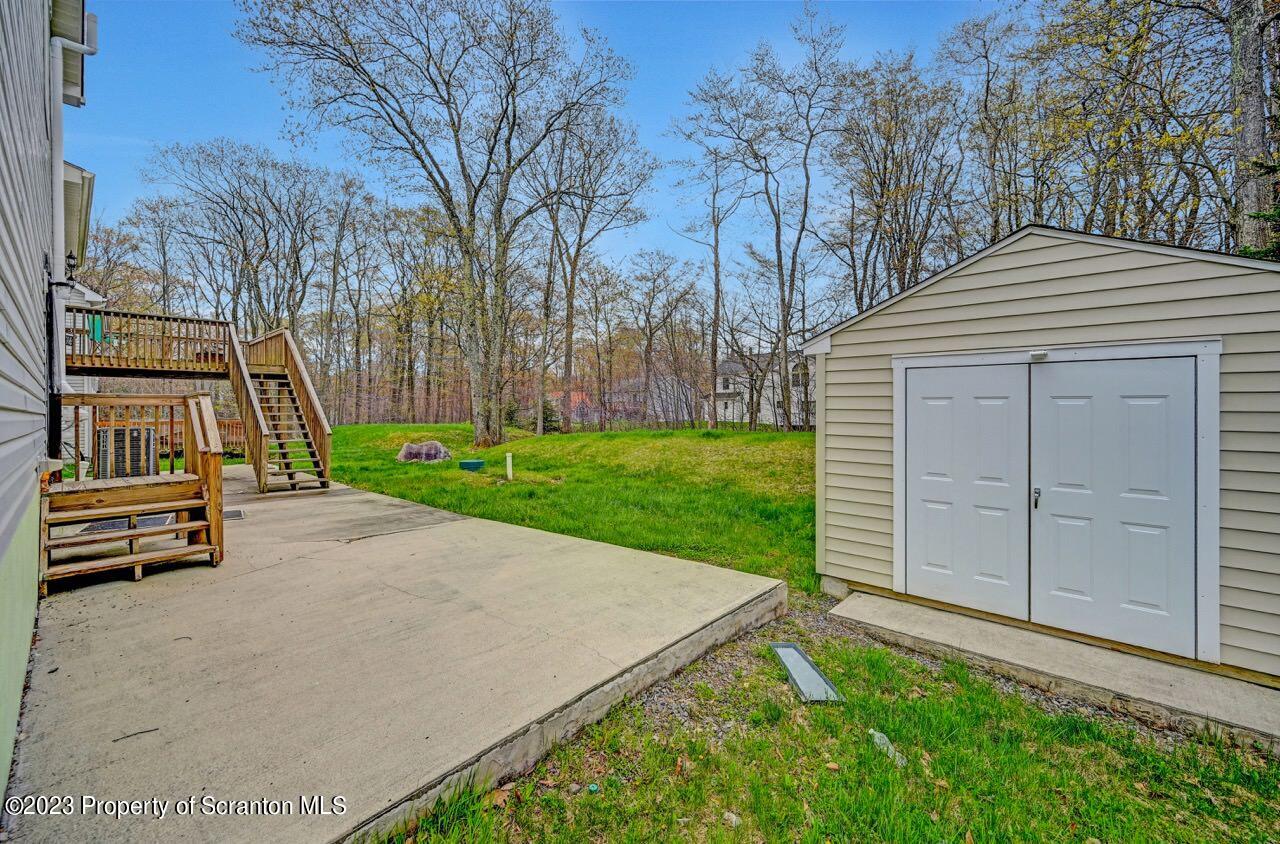 4156 Romeo Road Tobyhanna, PA 18466 - Photo 40 of 46 a view of a backyard with brick wall and plants