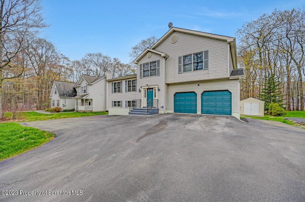 4156 Romeo Road Tobyhanna, PA 18466 - Photo 45 of 46 a front view of a house with a yard and garage
