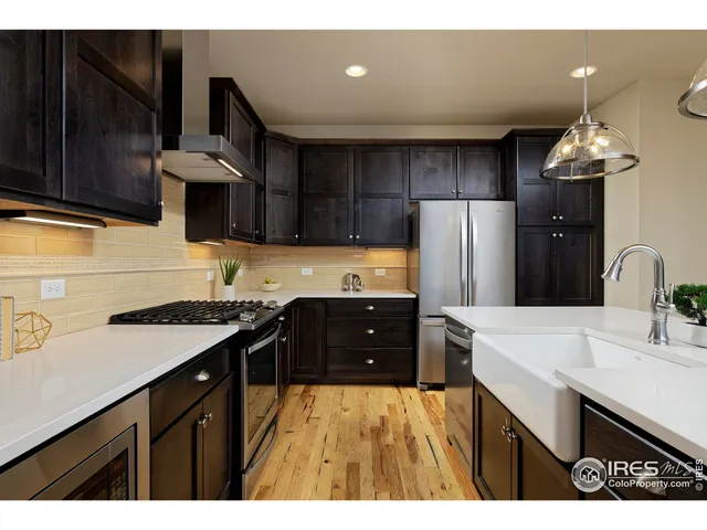 a kitchen with a sink a stove and refrigerator