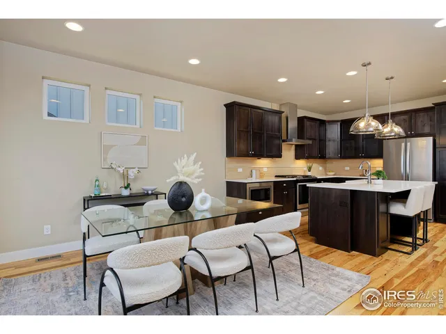 a kitchen with stainless steel appliances kitchen island granite countertop a sink and cabinets