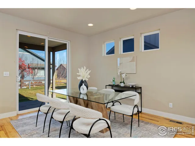 a living room with furniture and a painting on the wall