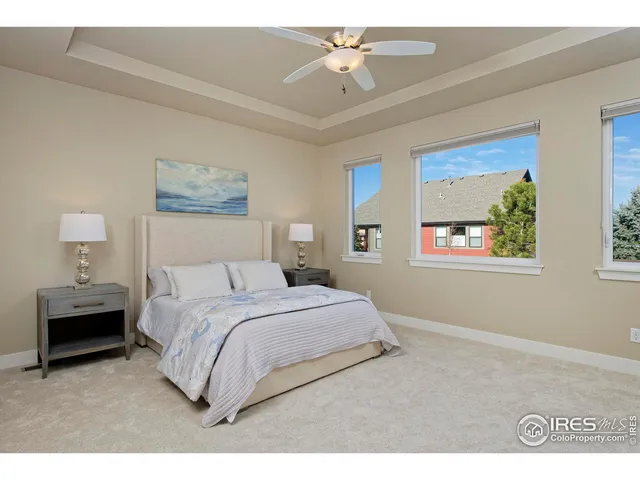 a bedroom with a bed and a painting on the wall