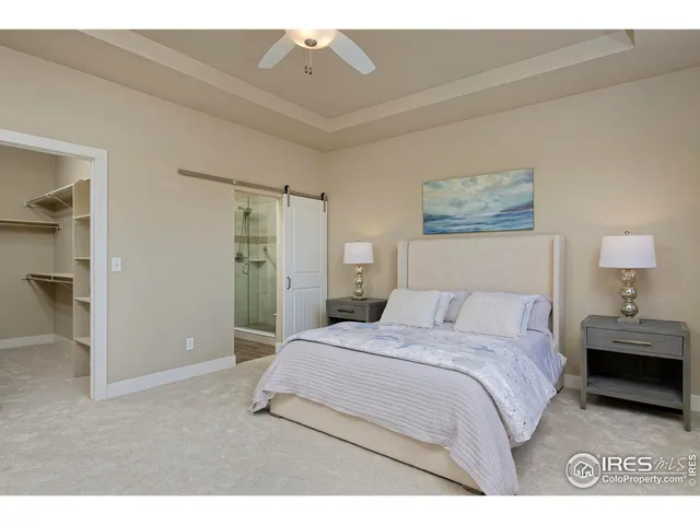 a bedroom with a bed and a painting on the wall