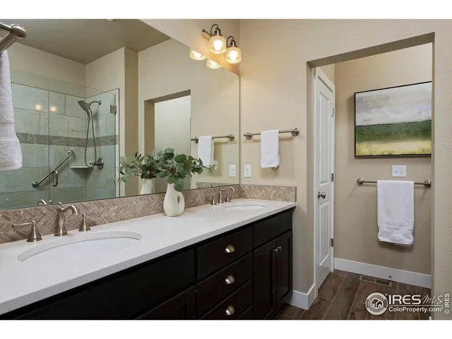 a bathroom with a sink double vanity and a mirror