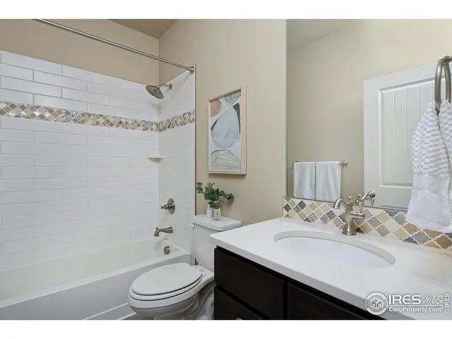 a bathroom with a granite countertop sink toilet a shower and a bathtub