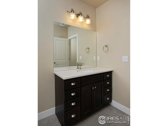 a bathroom with a sink vanity and a mirror