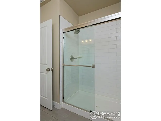 a bathroom with a shower and a mirror