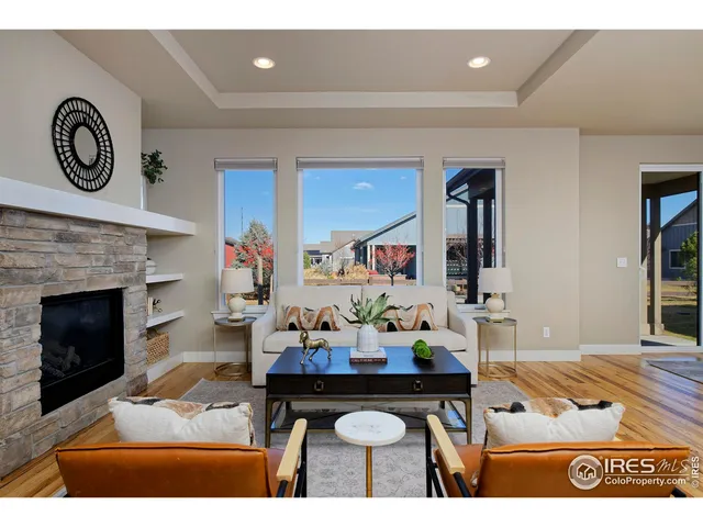 a living room with furniture a fireplace and a clock