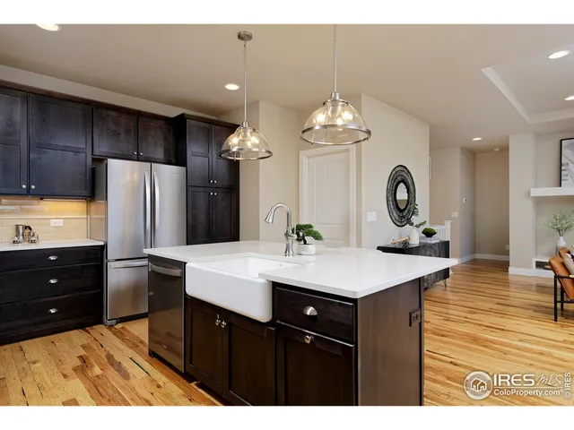 a kitchen with a refrigerator and a sink