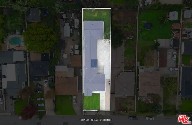 a large kitchen with stainless steel appliances granite countertop a large counter top and a wooden floors