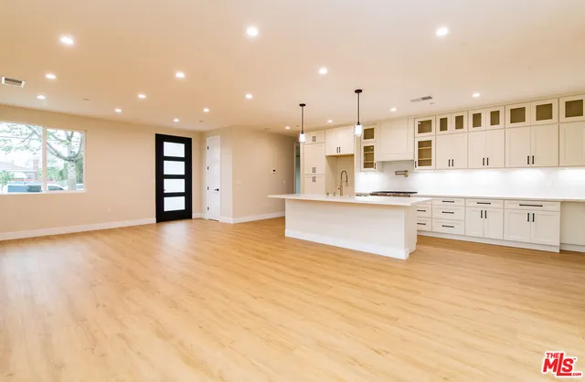 a kitchen with sink a stove and cabinets
