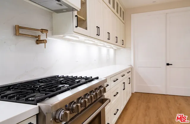a kitchen with stainless steel appliances granite countertop a stove and a refrigerator