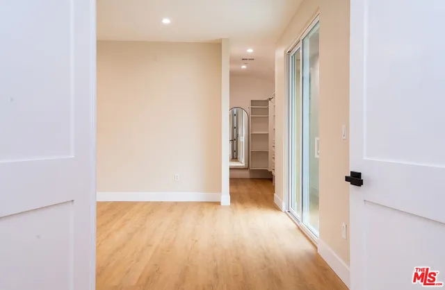 a view of a livingroom with a ceiling fan & window